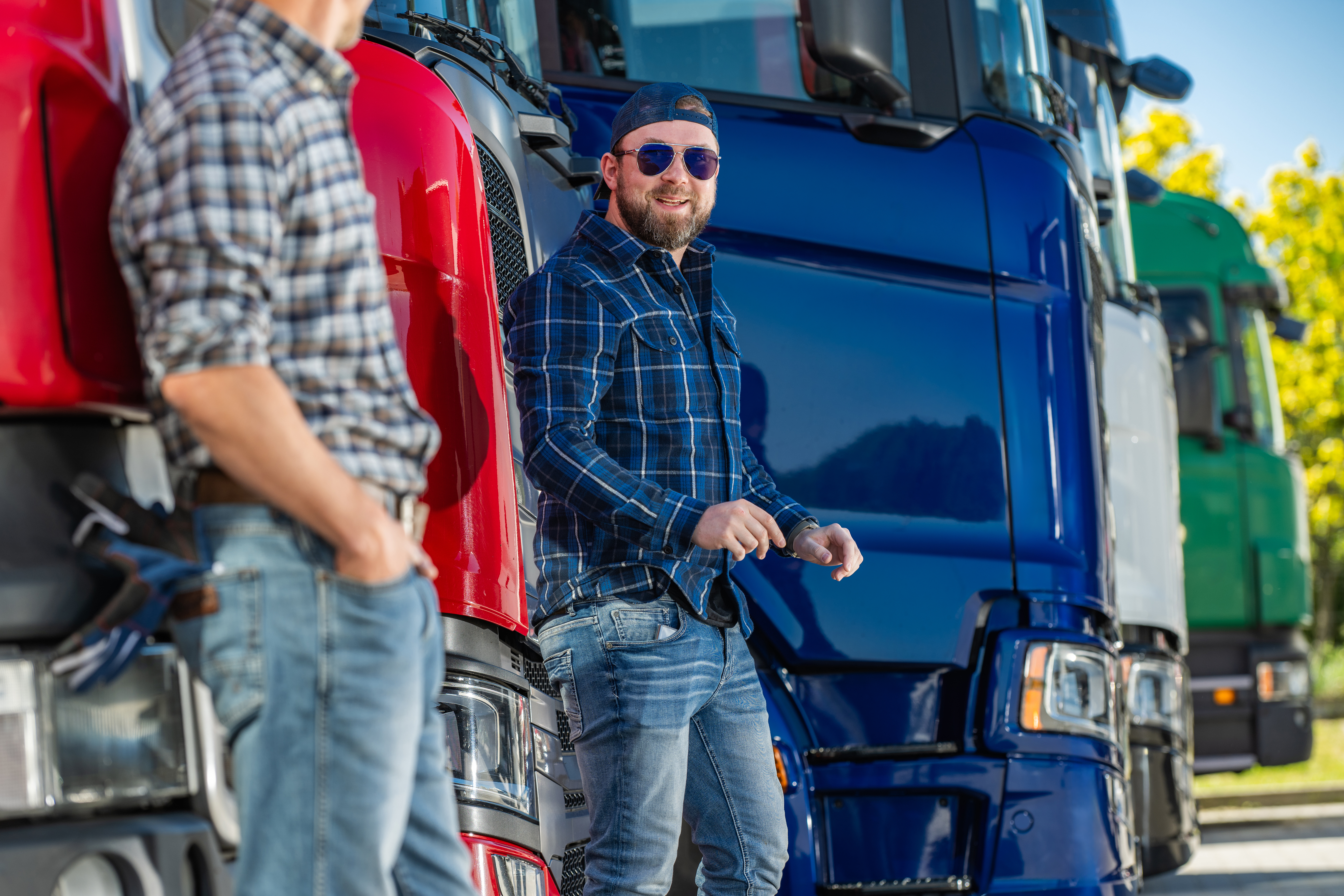 Truck operators talking in a transportation yard